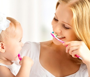 mommy and baby brushing teeth together