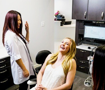 Laughing woman in dental chair