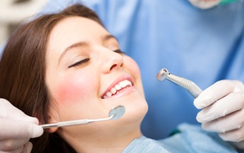 A young woman having her teeth checked at the dentist’s office