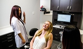 Laughing woman in dental chair