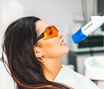 Woman receiving teeth whitening treatment