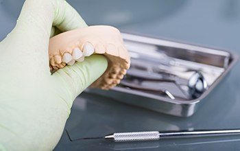 A lab technician creating a partial denture in Carrollton for a patient