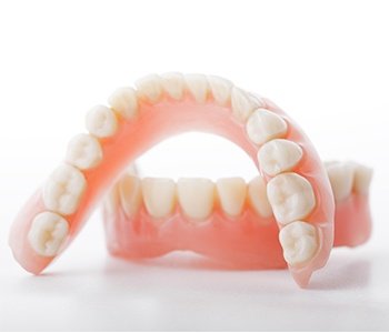 An up-close view of a set of full dentures, one of the upper arch and one for the lower arch