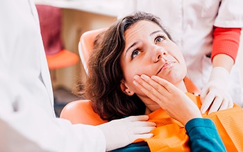 Pained woman visiting her Carrollton emergency dentist