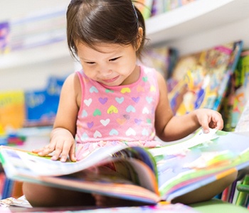 child reading a book in school