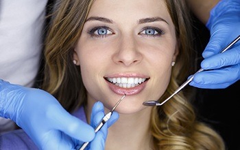 Smiling woman receiving dental care