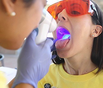 Woman receiving oral cancer screening