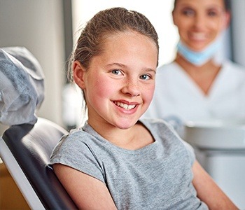 Smiling young girl in dental chair