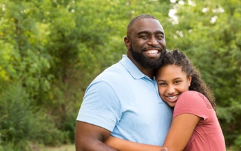 parent and child smiling and hugging each other