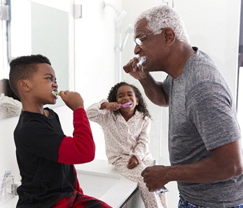 grandparent brushing their teeth with their grandchildren