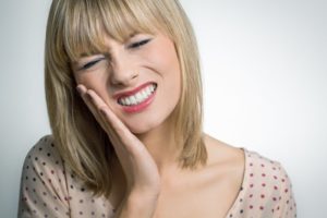 Woman holding jaw