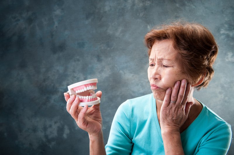 man holding dentures